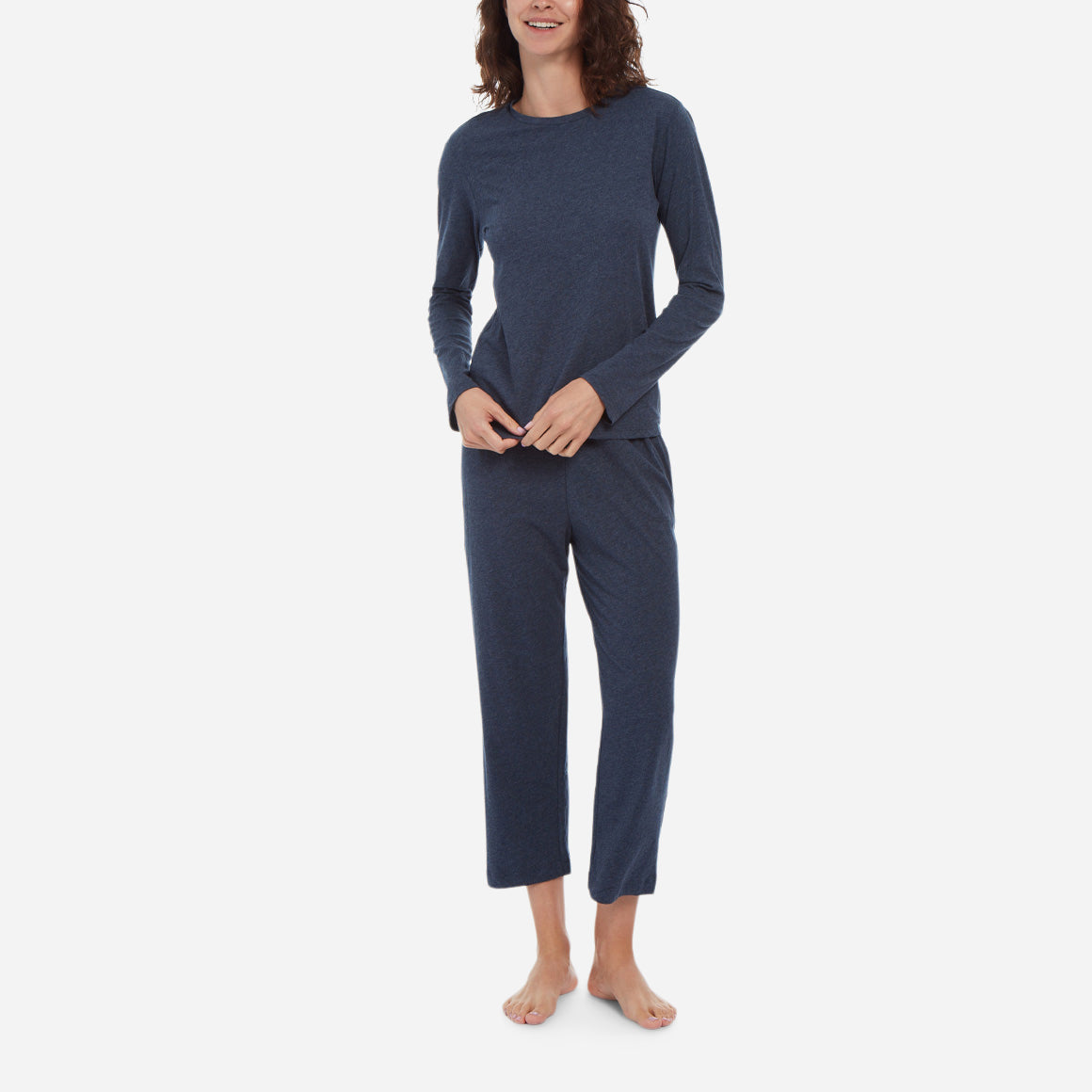 Front facing model wearing a long sleeve crewneck top with cropped pant in midnight colorway.
