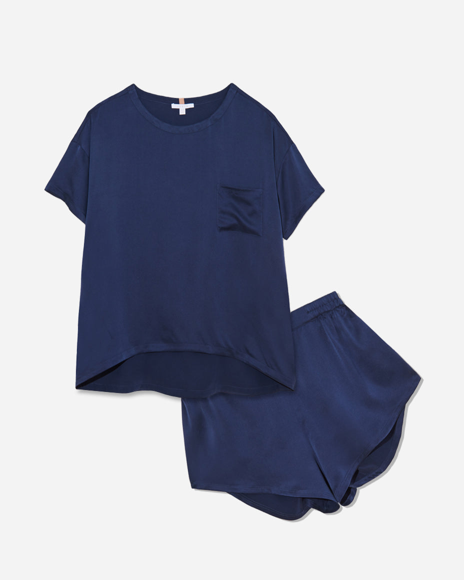 The set includes a short-sleeved tee and relaxed-fit shorts, both crafted from breathable silk fabric that is lightweight, comfortable, and machine washable. The shorts feature an elastic waistband for a perfect fit, while the tee is designed with a flattering neckline, chest pocket, and relaxed fit that drapes beautifully on the body.