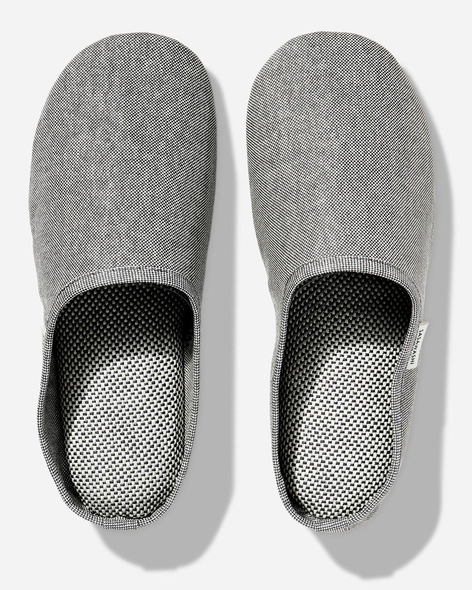 Japanese-style room slippers in light grey color photographed against a white background. Each slipper has Saswashi written on tag near foot opening.