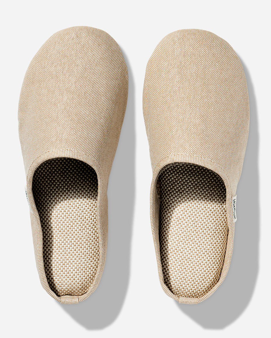 Japanese-style room slippers in beige colorway photographed against a white background. Each slipper has Saswashi written on tag near foot opening.