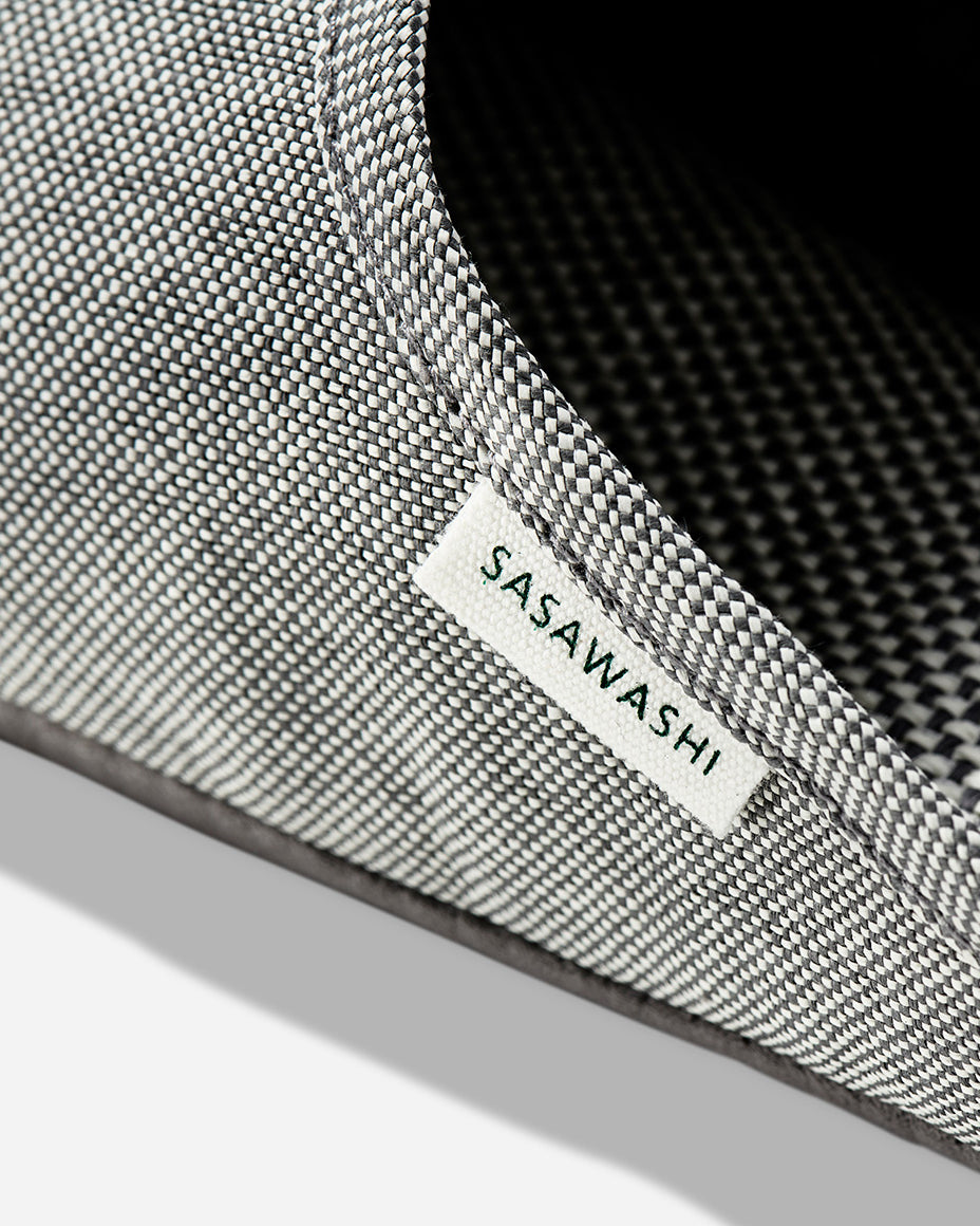 Up-close image of the side of a light grey slipper with Sasawashi written in black on a white tag.