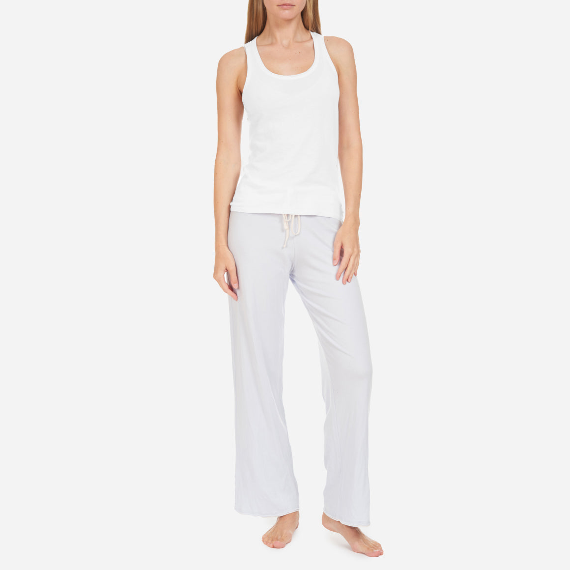 Skin’s Organic Pima Cotton Racerback Tank is the epitome of comfort and versatility. Made from the finest quality organic cotton, this lounge tank offers an unmatched level of softness and sustainability. The smooth, breathable fabric is gentle against your skin, providing a luxurious feel whether you’re lounging at home or running errands. The slim fit and timeless design of this tank top features a classic scoop neckline and alluring racerback, offering a perfect balance between style and comfort.