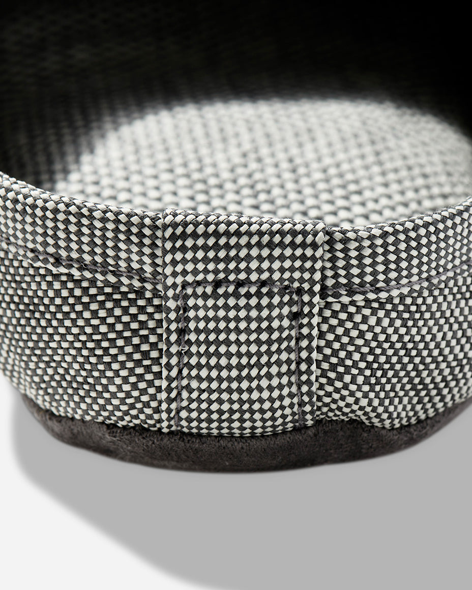 Up-close image of the heel of a light grey room slipper.