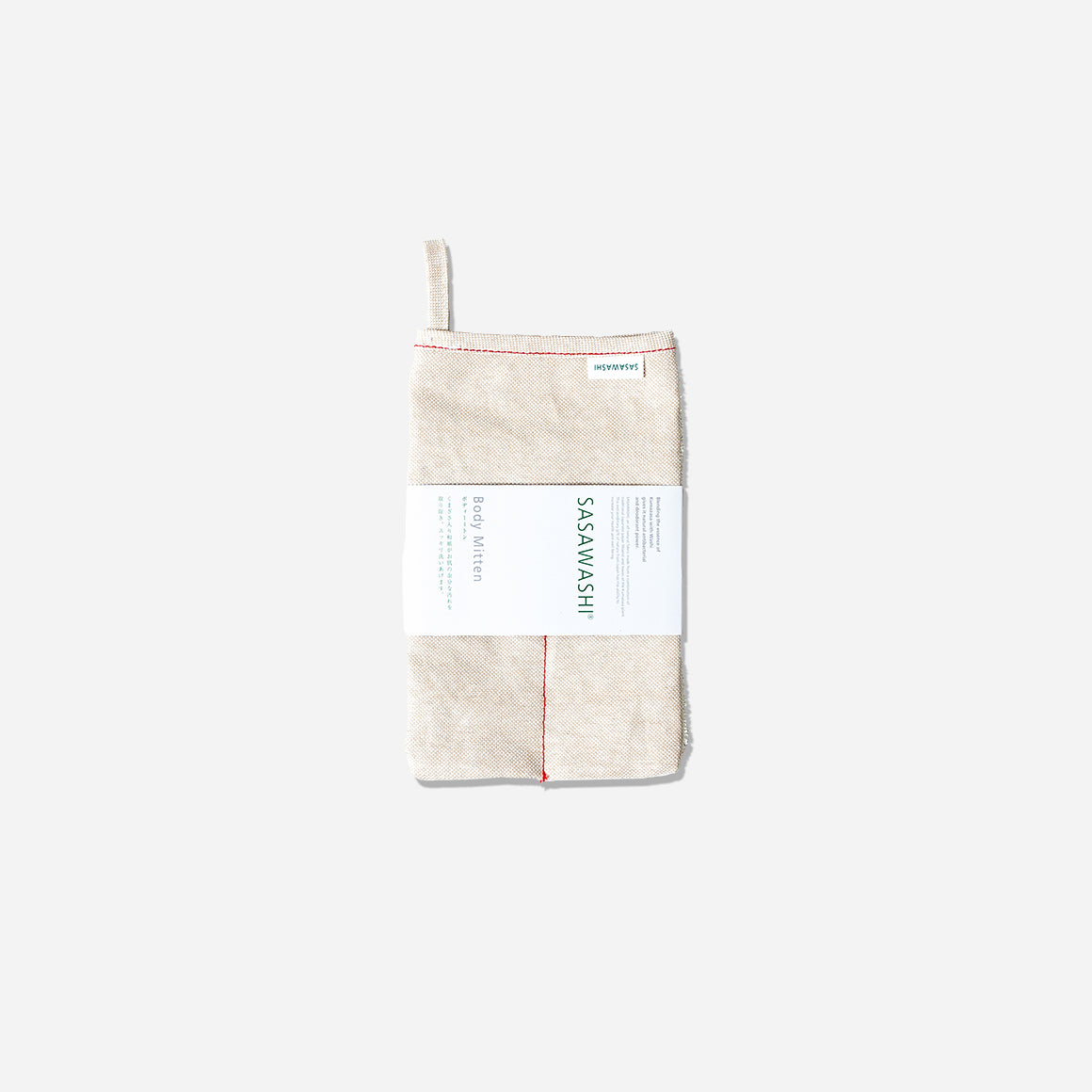 Smooth side of body scrub mitt. Cream colored with red piping. Product label wrapped around middle. Hang tab on top left corner.