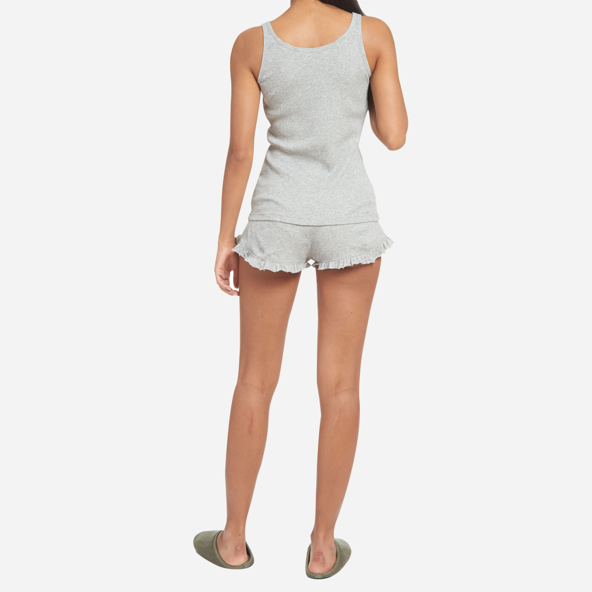 The design of the Raisa & Raffaela Set is as elegant as it is versatile. The classic fitted tank top has a flattering scoop neckline, while the cozy shorts offer a comfortable, yet flattering silhouette with an adorable ruffled edge. The elastic waistband with drawstring ensures a personalized fit for all body types.