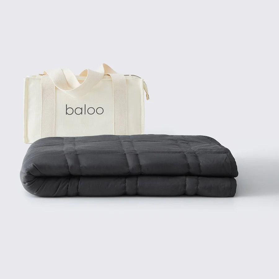 Gray weighted blanket with a white bag labeled 'baloo' on a light gray background