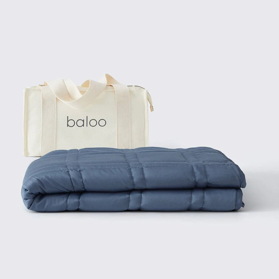 Blue weighted blanket with a 'baloo' branded bag on a white background