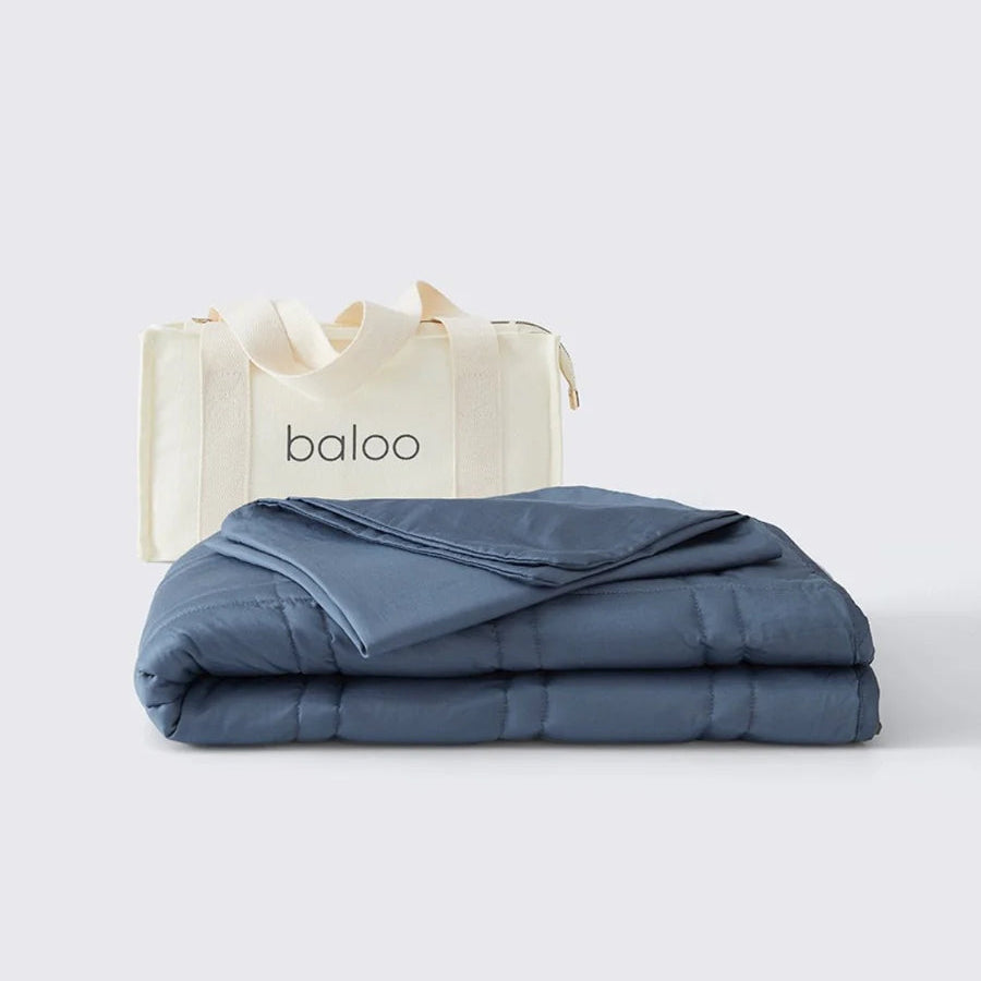 Folded blue blanket with 'baloo' branding on a white background