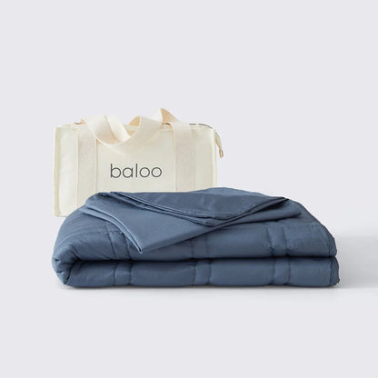 Folded blue blanket with 'baloo' branding on a white background