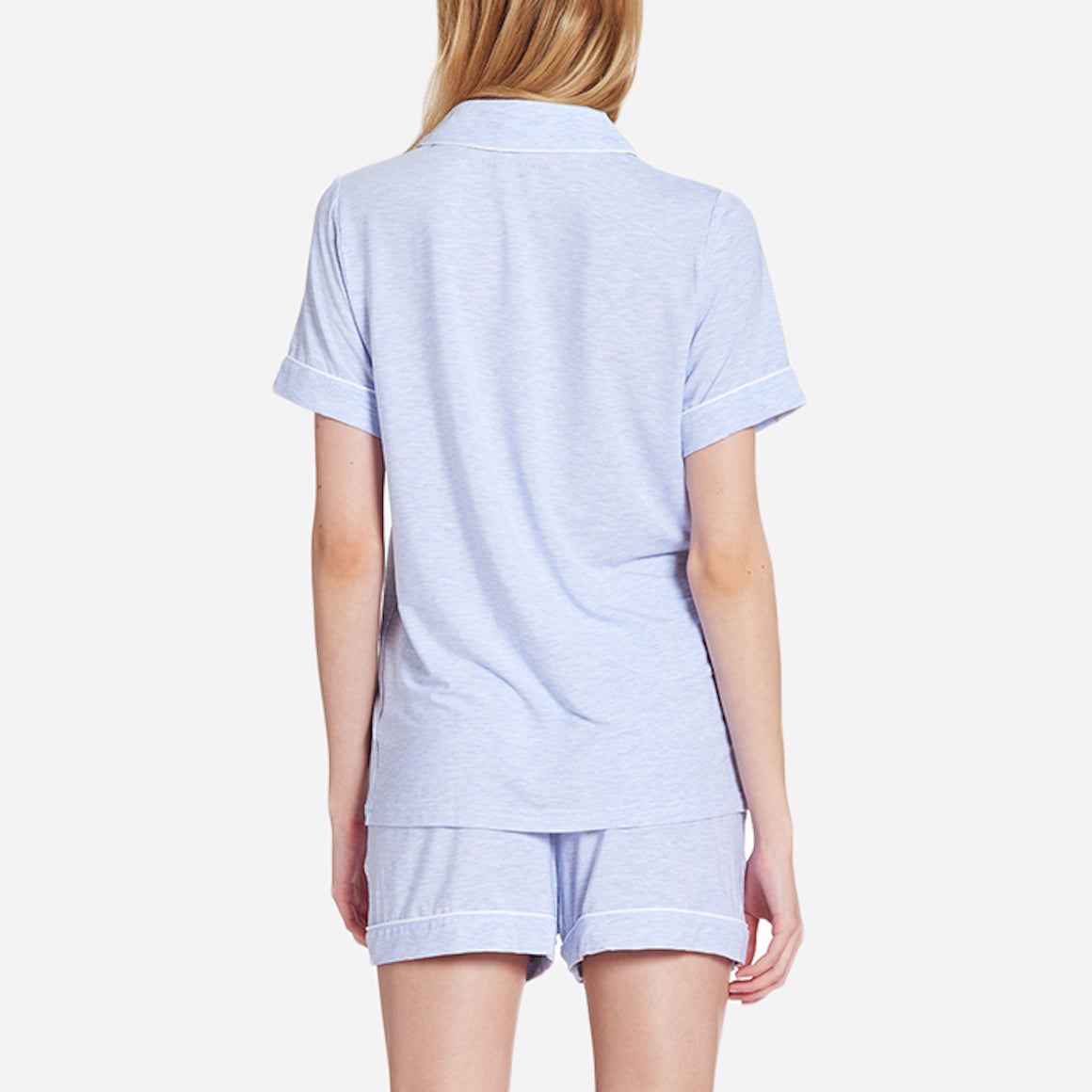 Back-facing model wearing a light blue short sleeve top and bottom pajama set.