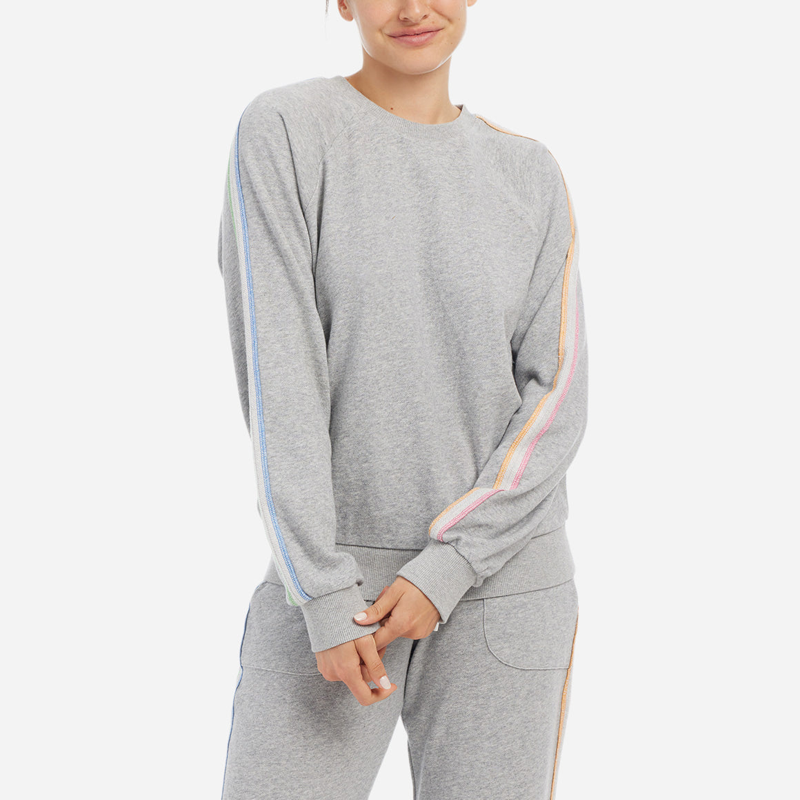 This cozy loungewear top features a relaxed fit and is detailed with neon stripes along the sleeves for a modern pop of color. 
