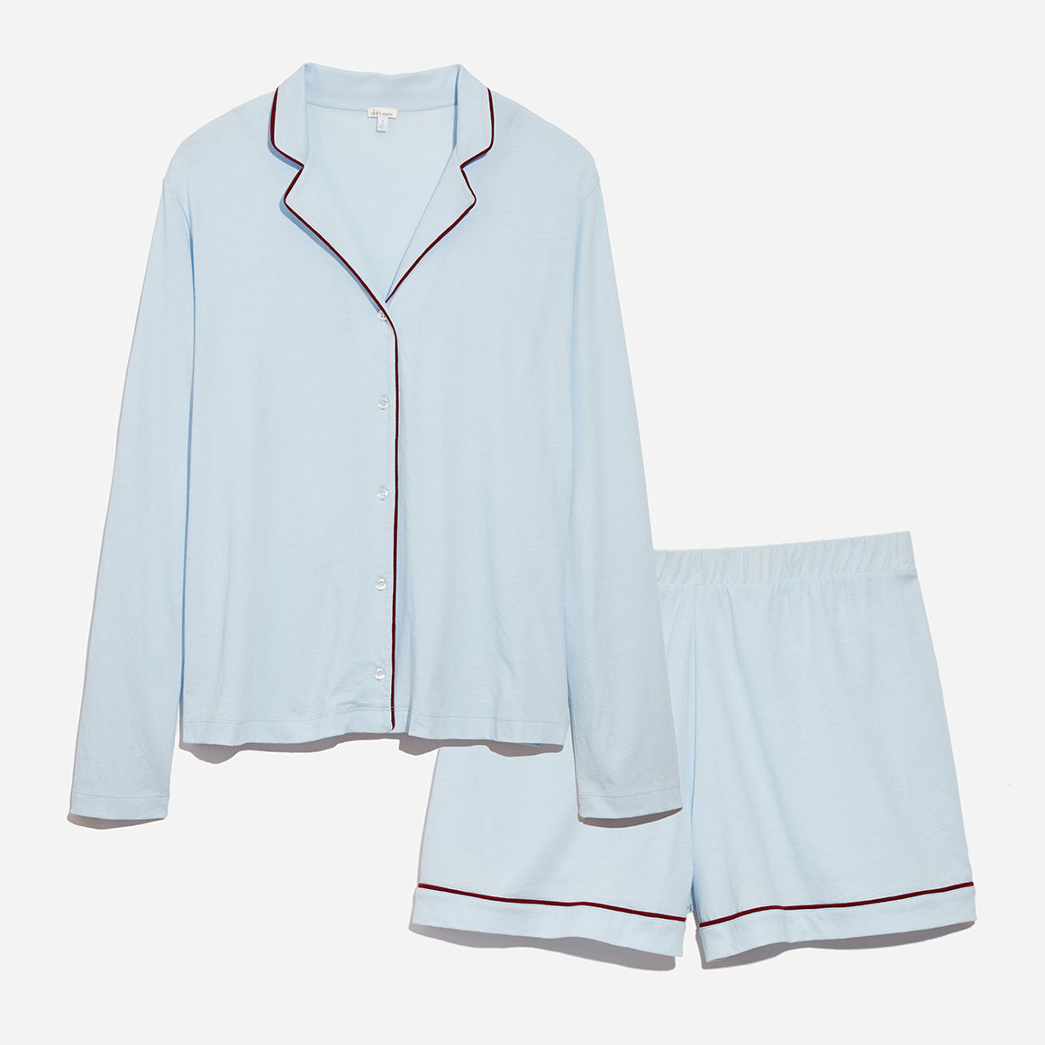 Light blue long sleeve pajama top paired with matching shorts, both with deep red piping with grey background.