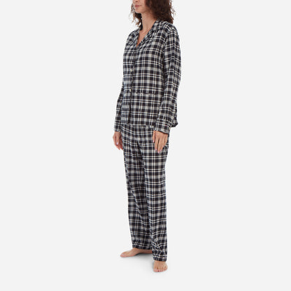 Female model side view wearing black and white plaid flannel pajamas.