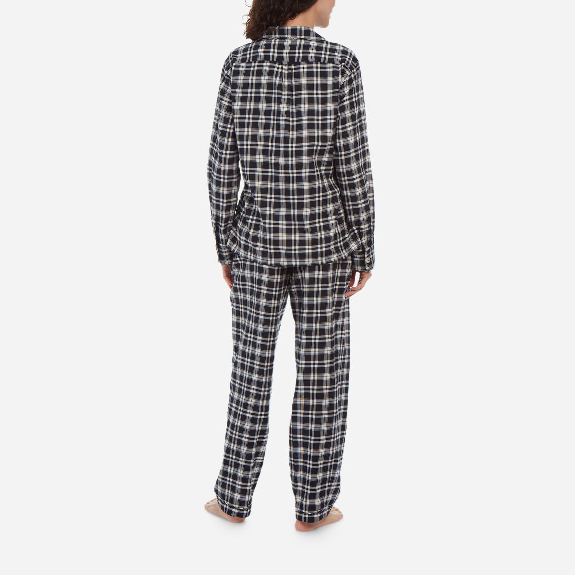 Rear facing model image wearing black and white plaid flannel long pajama set. 