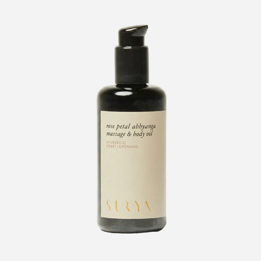 Bottle of Sera rose petal abhyanga massage & body oil on a light gray background