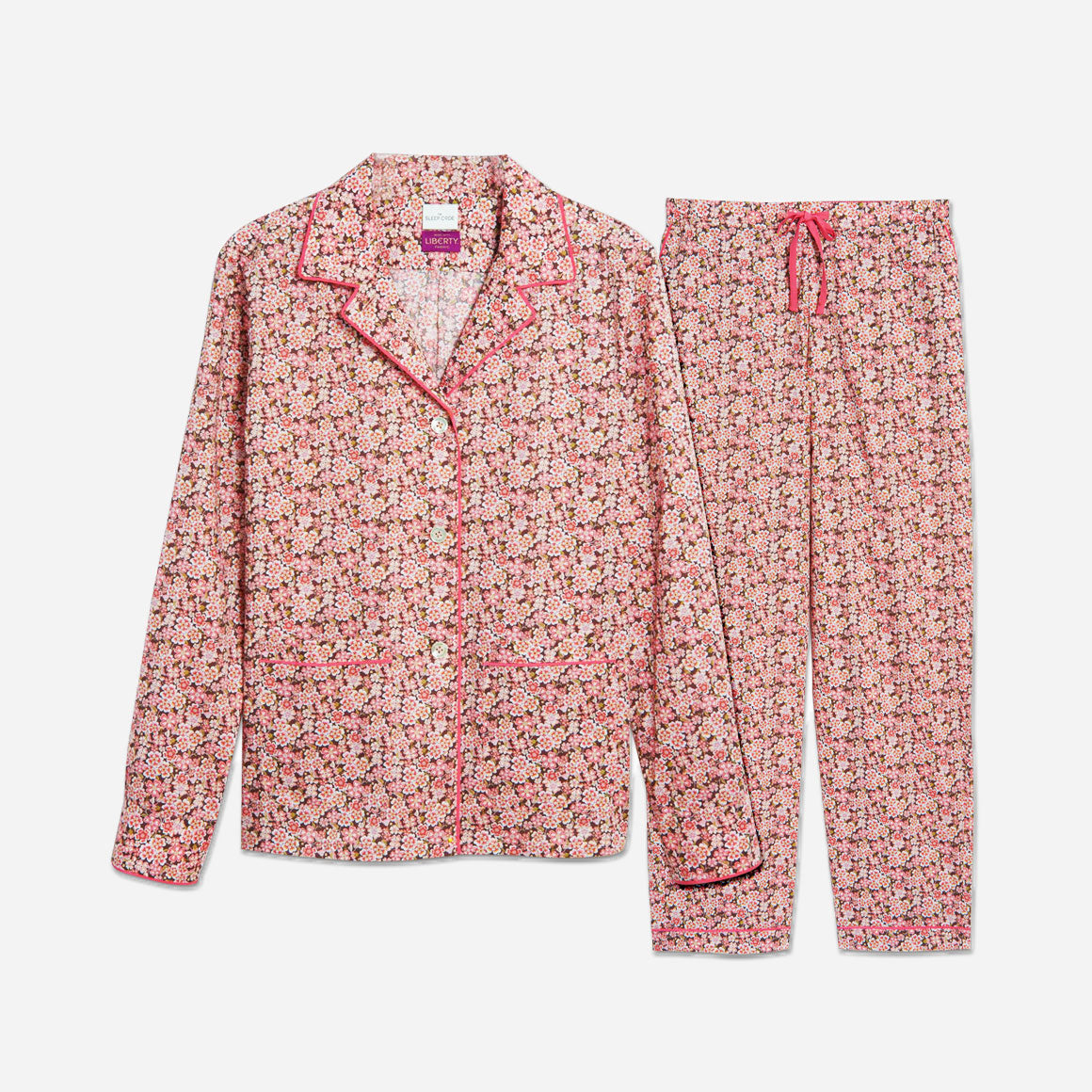 The pajama set includes a classic button-up top with a collar, two patch pockets, and functional button cuffs. The matching pair of pants features a comfortable elastic waistband, drawstring, and side-seam pockets. The long sleeves offer extra coverage and warmth for cooler evenings.
