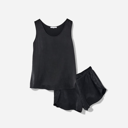 The set includes a sleeveless tee and relaxed-fit shorts, both crafted from breathable silk fabric that is lightweight, comfortable, and machine washable. The shorts feature an elastic waistband for a perfect fit, while the top is designed with a flattering neckline and relaxed fit that drapes beautifully on the body.