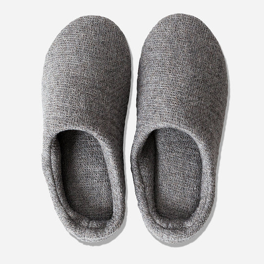 Top-down view of grey house slippers against white background.
