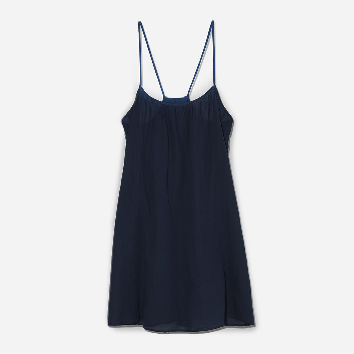  Loup Charmant’s Airy Cotton Mini Slip dress in navy. A semi-sheer slip with spaghetti straps and a rounded neckline. 