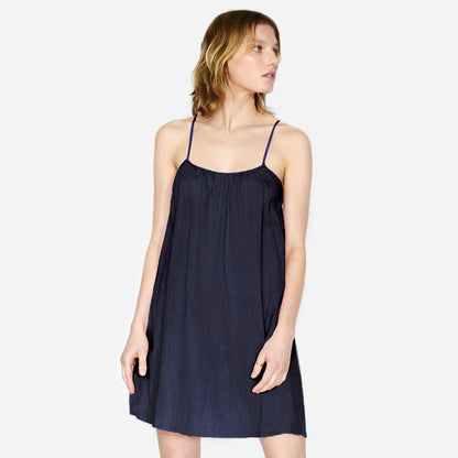 Airy Cotton Mini Slip dress in navy featured on model forward facing with slip dress cut above the knee. 