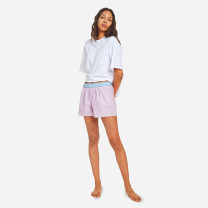 Our organic cotton boxer shorts feature a relaxed fit, button fly, and a soft elastic waistband that when folded over reveals a pop of contrast color. The lightweight fabric offers breathability and comfort for a peaceful night's sleep and a stylish look that is perfect for lounging at home.