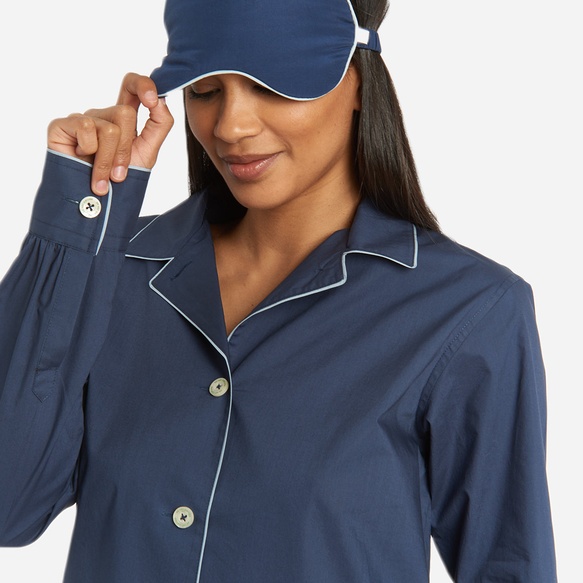 The pajama set includes a classic button-up top with a collar, two patch pockets, and functional button cuffs. The matching pair of pants features a comfortable elastic waistband, drawstring, and side-seam pockets. This cozy pj set is a timeless and stylish look that is perfect for lounging at home.
