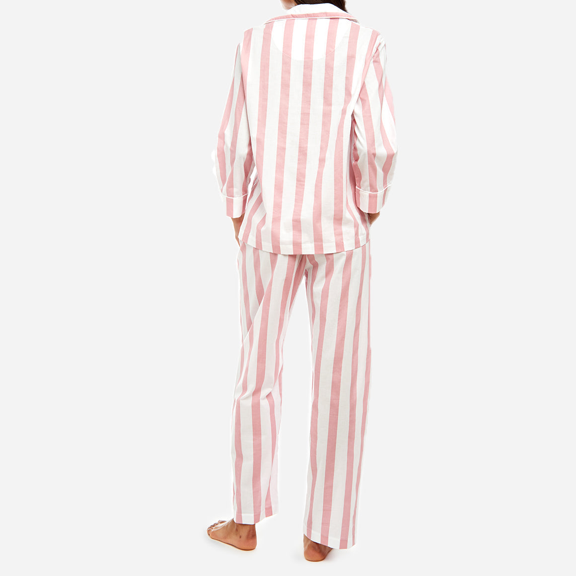 This striped set is made from breathable and soft GOTS-certified organic cotton voile that feels light and airy on your skin. The pajama shirt has a boxy fit for unrestricted movement, while the straight leg pants feature a comfy elastic waist for a custom fit that can be worn high on the waist or low on the hips.
