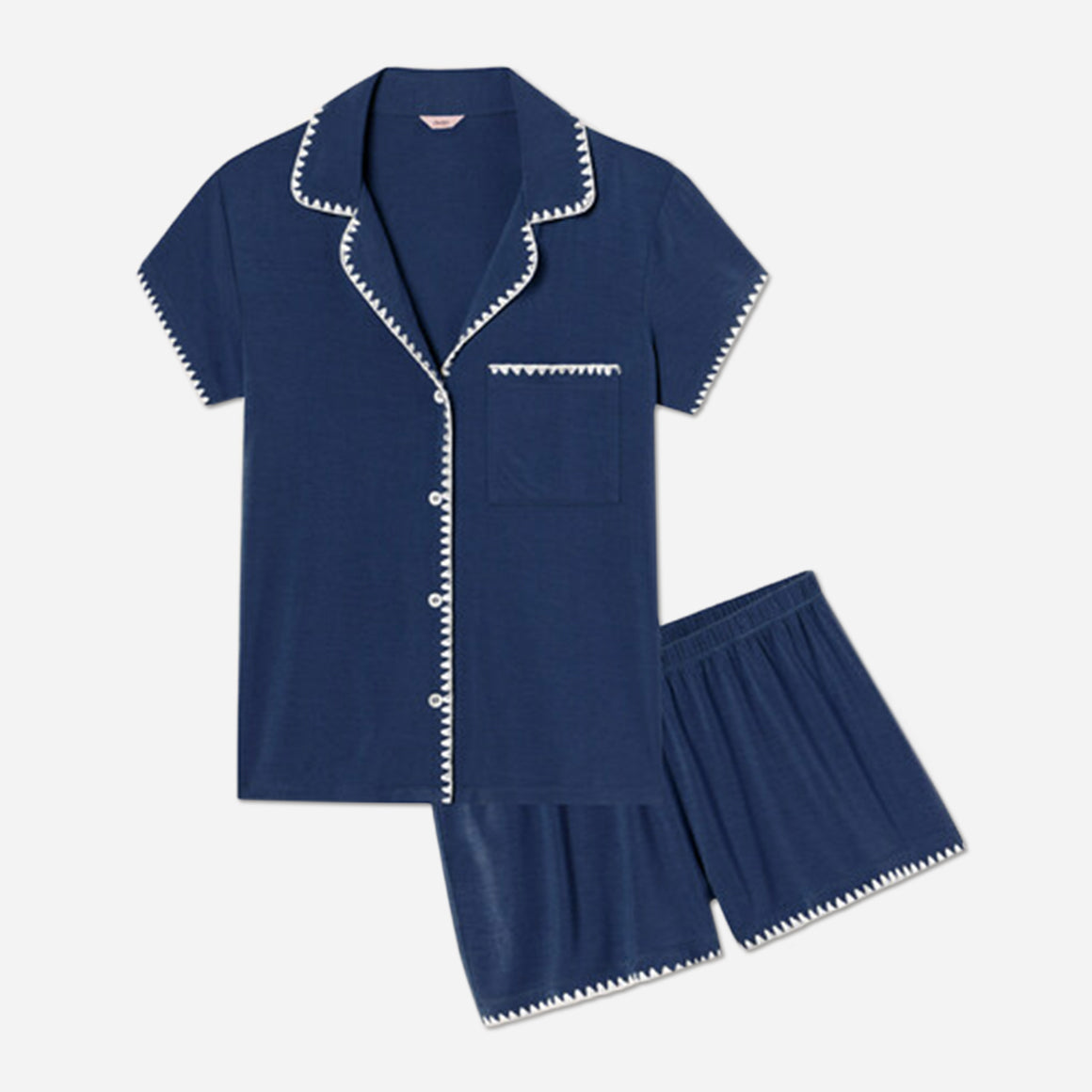 The classic slim-fit short-sleeve top boasts a button front with a notch collar and functional pocket, while the low-rise cheeky short with a thin elastic waistband ensures maximum comfort and style. Made with sustainable TENCEL™ Modal knit, this PJ set feels luxuriously soft and drapes gently over the body.