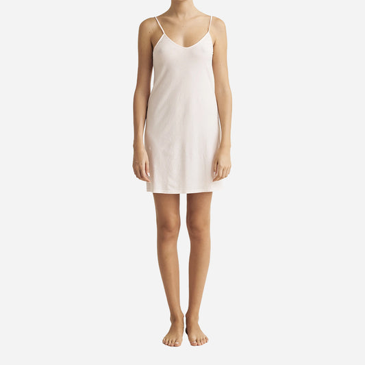 This slip features a v-neckline that accentuates your curves, creating a stunning silhouette that is both elegant and alluring. Crafted with meticulous attention to detail, this above the knee slip is made from luxurious organic pima cotton jersey which feels soft and gentle against your skin. The delicate straps add a stylish touch, while the flattering drape of the fabric will make this a favorite of your nighttime routine.