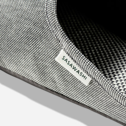 Up-close image of the side of a light grey slipper with Sasawashi written in black on a white tag.