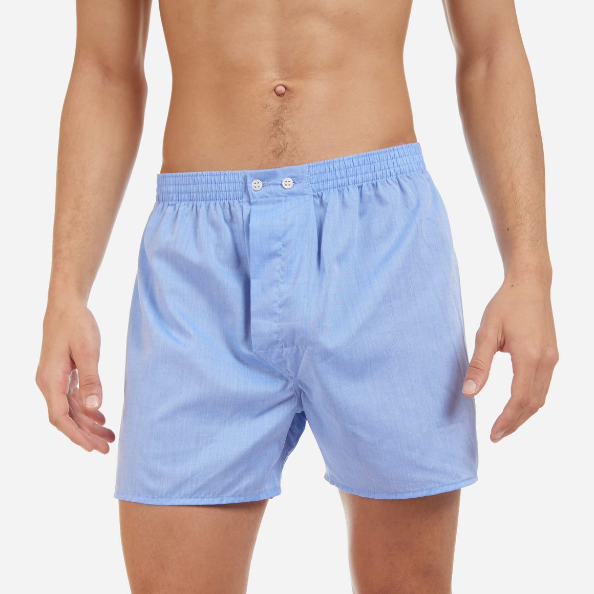 A front-facing model is wearing a classic fit boxer in. blue made 100% cotton. Model is shirtless.