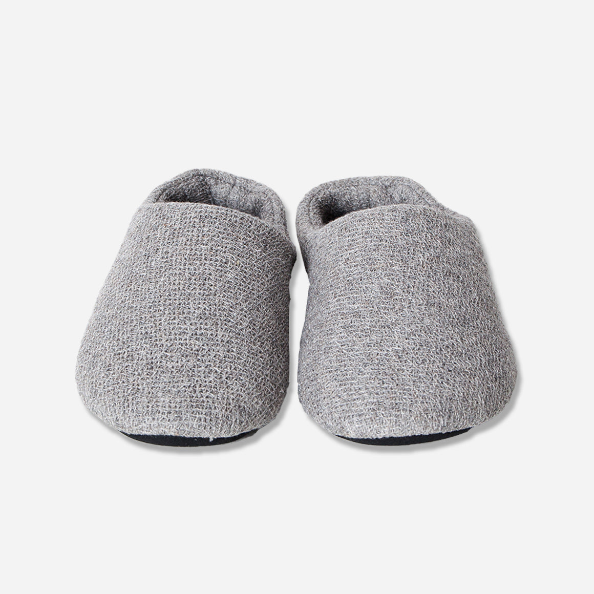 Front view of toe box of grey house slippers. Shot against white background.