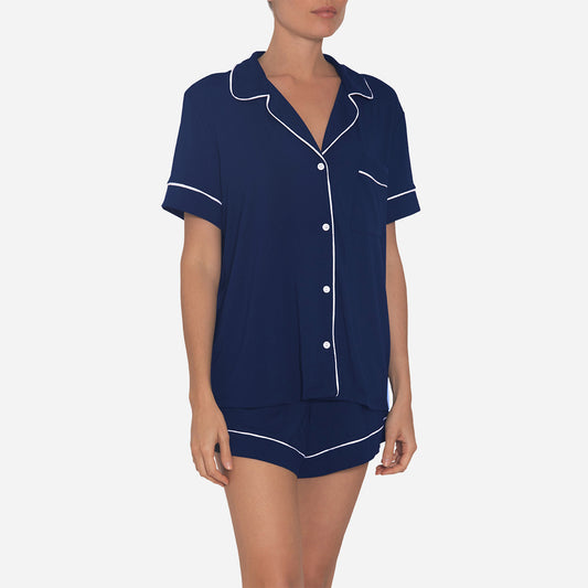 The timeless design of the Gisele Shortie Short Pajama Set is accentuated by its tailored cut and refined detailing. The delicate contrast piping along the edges adds an understated charm, elevating the overall aesthetic. The button-down front allows for easy wearing and effortless style, while the matching shorts feature an elastic waistband that provides a customized fit.