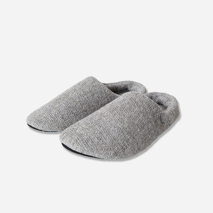 Angled view of grey slippers against white background.