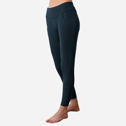 Dark Blue lounge and sleep jogger pant on side facing model with thick elasticated waistband sitting at the hip. 