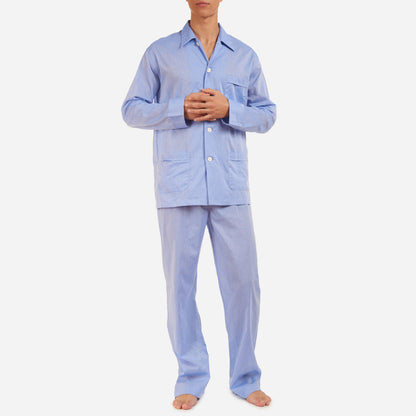 A front-facing model is wearing a classic fit long pajama set made of blue cotton batiste fabric.