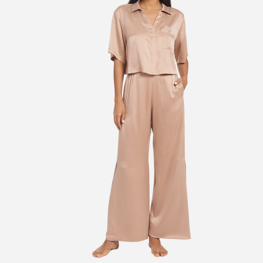 The high-waisted pants have pockets at the hip and side slits at the ankles for added ventilation. The matching short sleeve top is cropped at the waist, has a flattering v-neckline, and chest pocket. The lightweight and breathable fabric makes it perfect for lounging or sleeping, while the elegant design adds a touch of sophistication to your sleepwear collection.