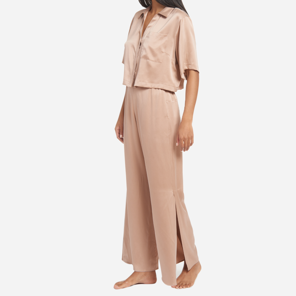 The high-waisted pants have pockets at the hip and side slits at the ankles for added ventilation. The matching short sleeve top is cropped at the waist, has a flattering v-neckline, and chest pocket. The lightweight and breathable fabric makes it perfect for lounging or sleeping, while the elegant design adds a touch of sophistication to your sleepwear collection.