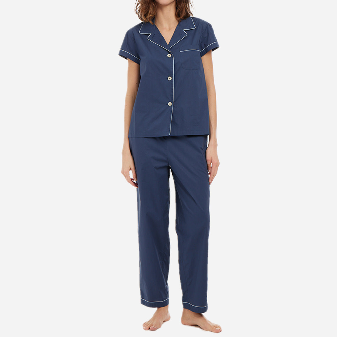 Dark blue short sleeve button-up top with matching full-length pants on a female model.