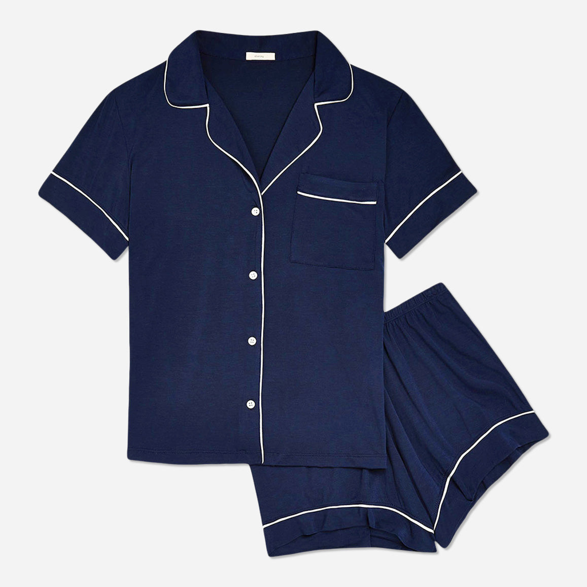 The timeless design of the Gisele Shortie Short Pajama Set is accentuated by its tailored cut and refined detailing. The delicate contrast piping along the edges adds an understated charm, elevating the overall aesthetic. The button-down front allows for easy wearing and effortless style, while the matching shorts feature an elastic waistband that provides a customized fit.