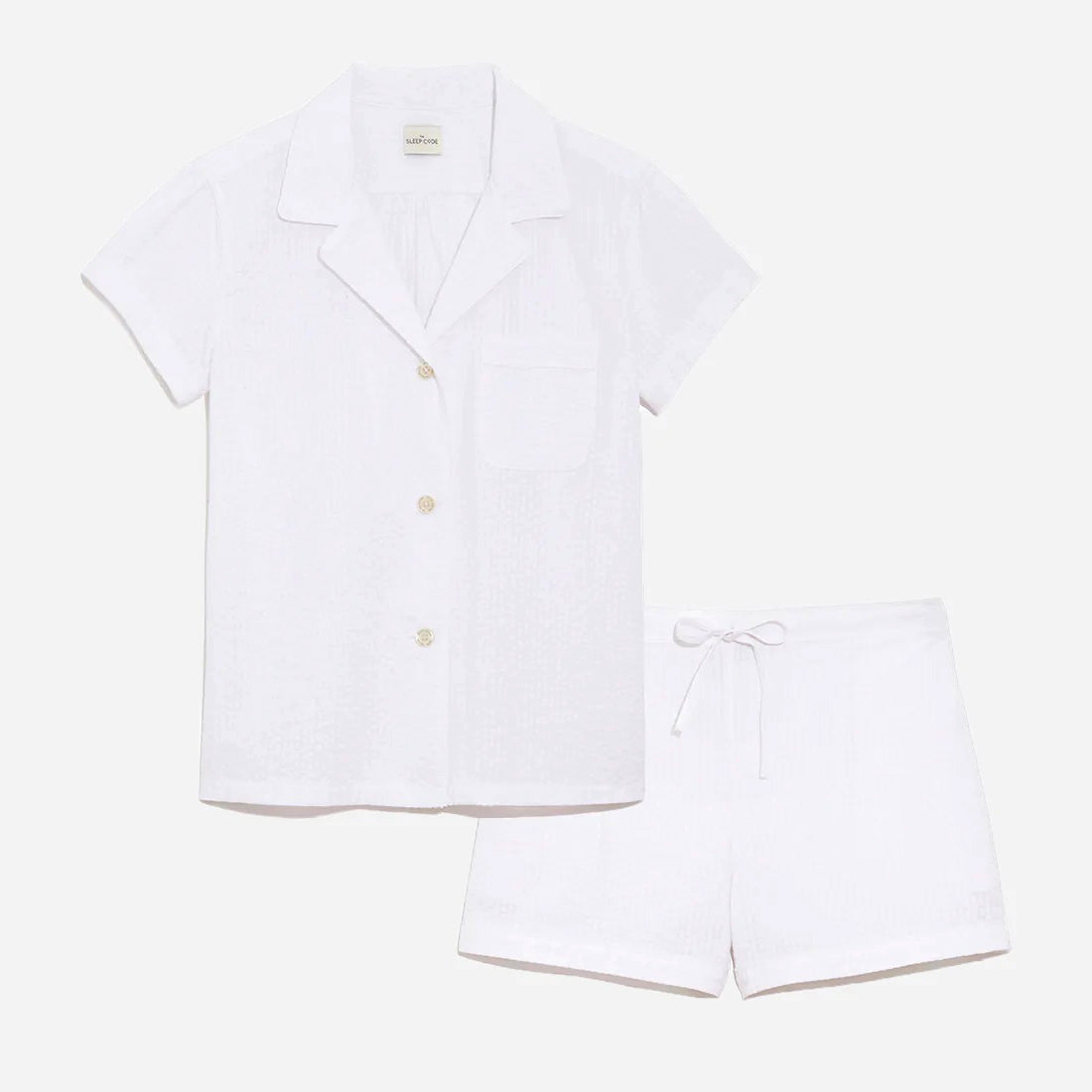 Our short sleeve pajama set features a relaxed fit, providing you with a cool and comfortable option for warmer weather. The pajama set includes a classic button-up top with a collar, while the matching shorts feature a comfortable elastic waistband, drawstring, and side-seam pockets.