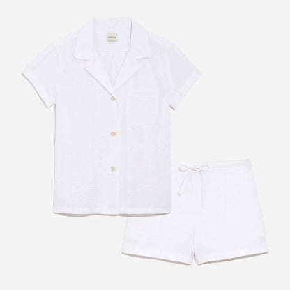 Our short sleeve pajama set features a relaxed fit, providing you with a cool and comfortable option for warmer weather. The pajama set includes a classic button-up top with a collar, while the matching shorts feature a comfortable elastic waistband, drawstring, and side-seam pockets.