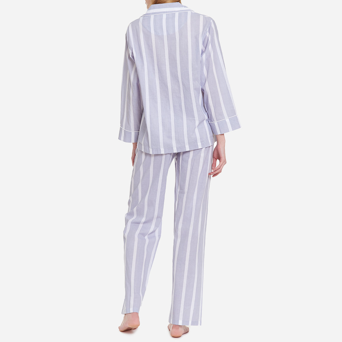 This striped set is made from breathable and soft GOTS-certified organic cotton voile that feels light and airy on your skin. The pajama shirt has a boxy fit for unrestricted movement, while the straight leg pants feature a comfy elastic waist for a custom fit that can be worn high on the waist or low on the hips.