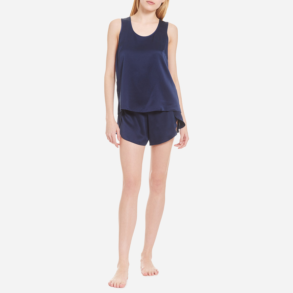 The set includes a sleeveless tee and relaxed-fit shorts, both crafted from breathable silk fabric that is lightweight, comfortable, and machine washable. The shorts feature an elastic waistband for a perfect fit, while the top is designed with a flattering neckline and relaxed fit that drapes beautifully on the body.
