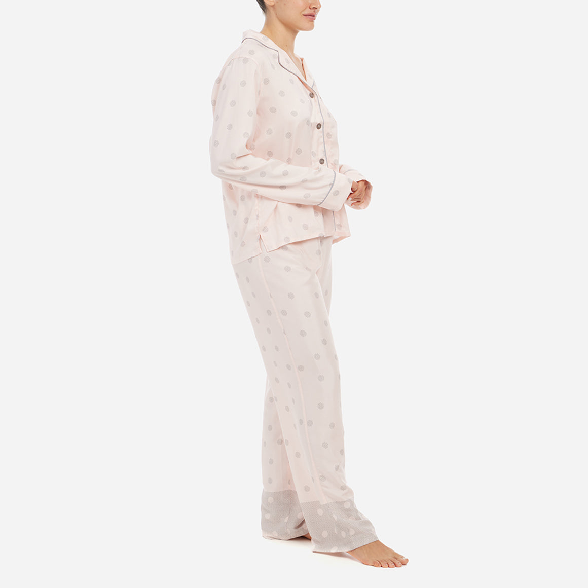 The classic yet contemporary silhouette flatters all body types, and its relaxed fit allows for unrestricted movement and maximum comfort, ensuring you wake up feeling refreshed and rejuvenated. The button-down top exudes sophistication, while the notched collar adds a touch of refinement. The matching straight leg pants offer a modern and flattering look, while the elastic waistband provides a customized fit.